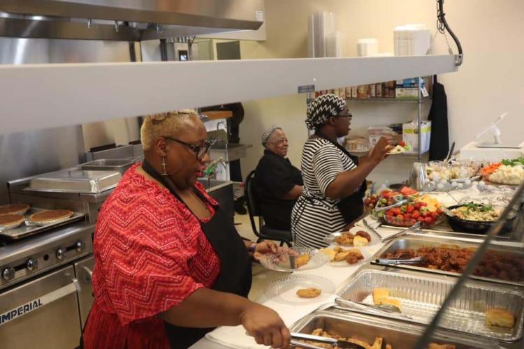 Three women work in the kitchen at Ada's Kitchen, a soul food restaurant in Louisville, KY