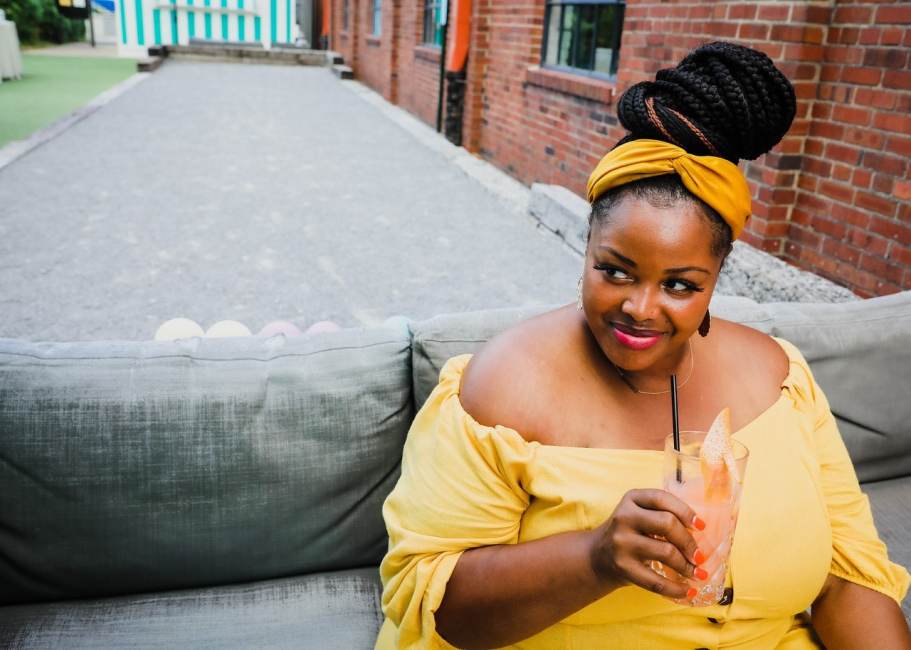 Louisville Guest blogger Andrea Meriwether in yellow dress enjoying cocktail