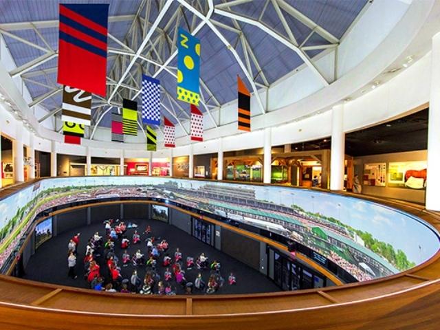 An aerial shot of viewers enjoying The Greatest Race film at the Kentucky Derby Museum.