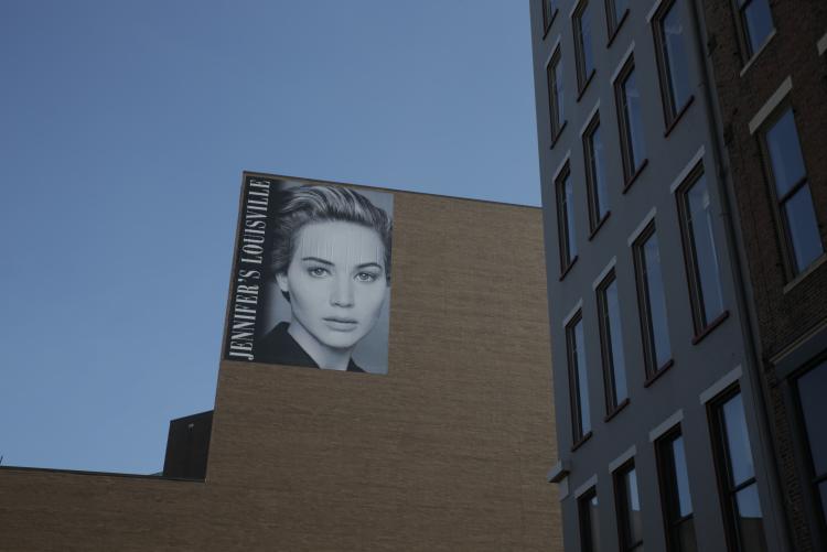 A large mural of actress Jennifer Lawrence on the side of a building in Louisville, KY