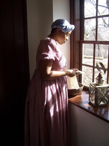 Unfolding the Story reenactor portrays Louisa, an enslaved individual on the 19th-century farm.