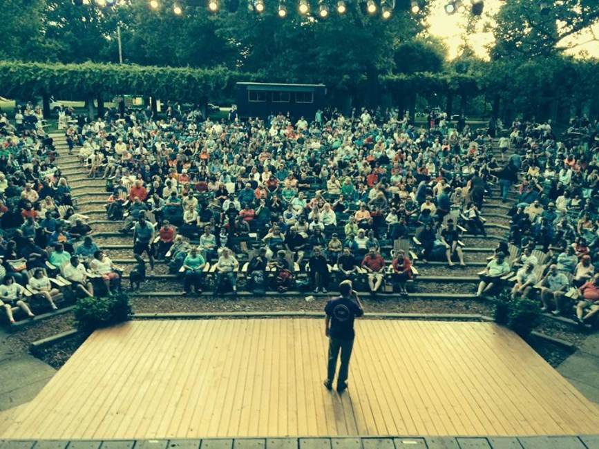 Matt Wallace stands on stage in front of a large crowd in Louisville