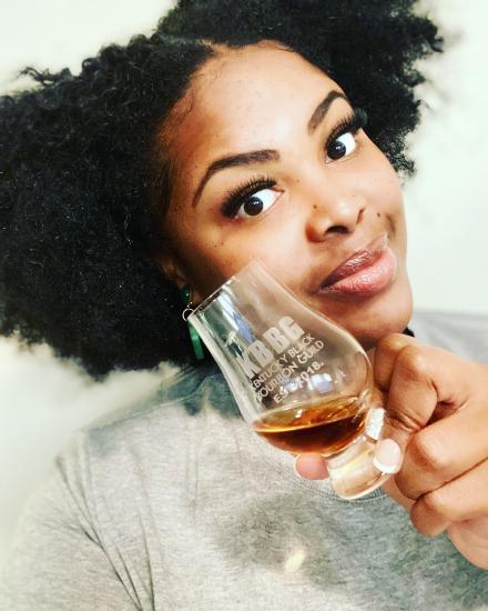 Louisville Guest Blogger Andrea Meriwether holding a glass of Kentucky bourbon
