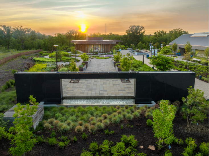 Sunset over the Water Wall and landscaped gardens at Waterfront Botanical Gardens in Louisville, Kentucky.