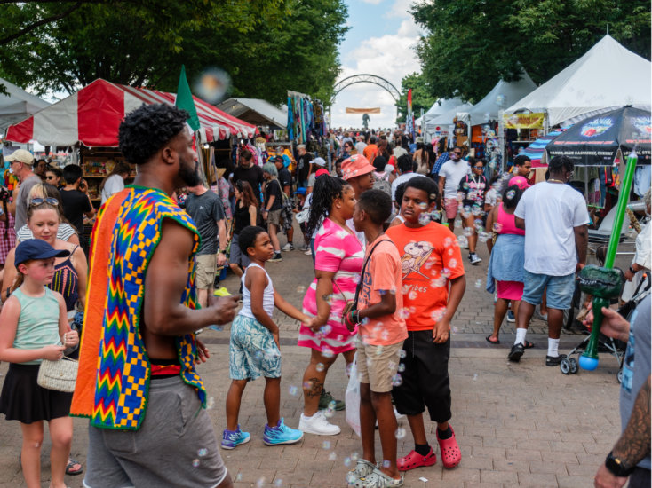 Crowds enjoy WorldFest in Louisville, KY, with food, crafts, music, and bubbles creating a lively cultural celebration.