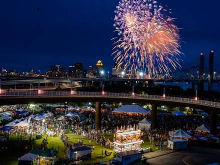 Waterfront festival at night time with fireworks and vendors