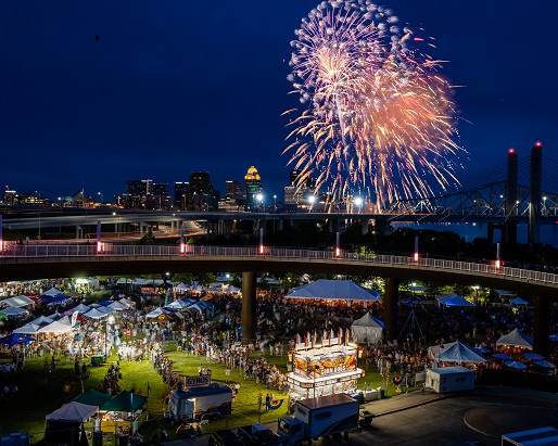 Waterfront festival at night time with fireworks and vendors