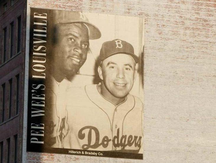 mural of Bud Hillerich and Pee Wee Reese on a painted brick building in Louisville