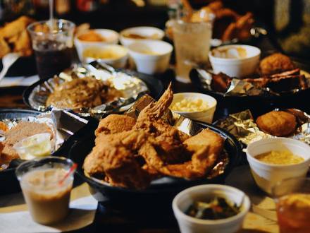 a table covered with fried foods and a wide variety of sides at Shirley Mae's Café, a soul food restaurant in Louisville, KY