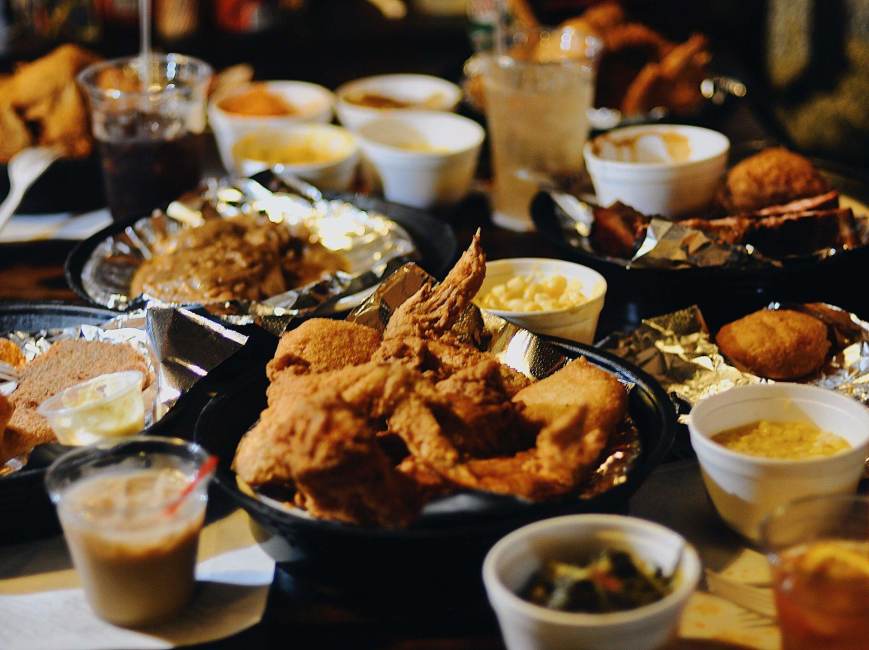 a table covered with fried foods and a wide variety of sides at Shirley Mae's Café, a soul food restaurant in Louisville, KY