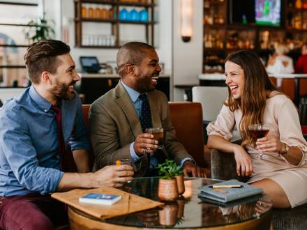 Business looking professionals enjoying a drink of bourbon at Porch Kitchen and Bar in Louisville, Kentucky.